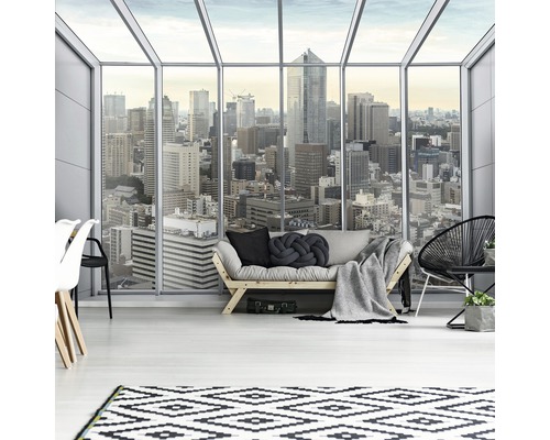 Heller Wohnraum mit Sofa, Teppich und Blick auf eine Stadt