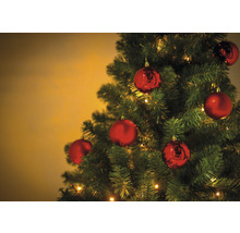 Geschmückter Christbaum mit roten Kugeln und Lichtern.