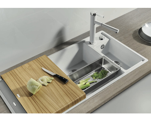 Küchenspüle mit Schneidebrett, Abtropfschale und Armatur auf einer Küchentheke