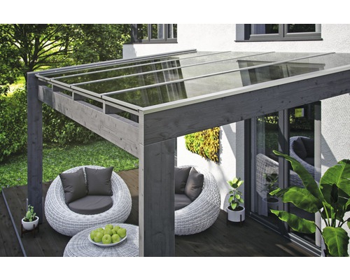 Terrassenüberdachung aus Holz mit Glasdach und Sitzgruppe auf einer Terrasse
