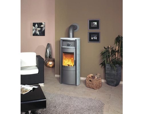 Wohnzimmer mit Kaminofen, Sessel, Tisch, Pflanze und Dekoration