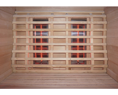 Innenansicht einer Infrarotsauna mit Holzverkleidung und Infrarotstrahlern hinter einem Schutzgitter.