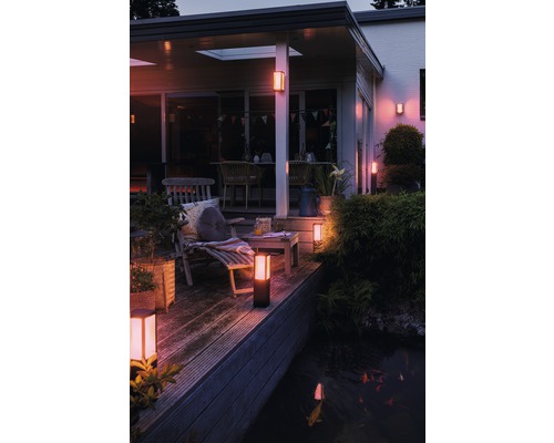 Beleuchtete Terrasse mit Gartenleuchten, Gartenmöbeln und Teich