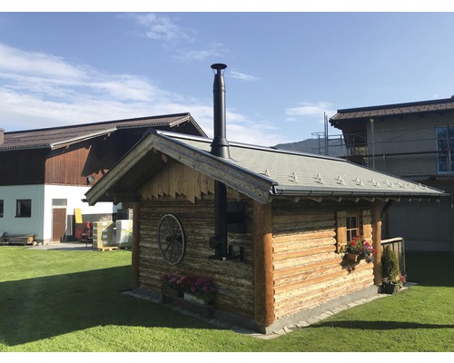Holzsauna mit Schornstein und Blumenschmuck im Garten