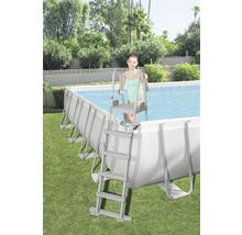 Schwimmbecken mit Leiter im Garten mit junger Frau