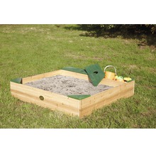 Quadratischer Sandkasten aus Holz mit Deckel und Spielzeug auf einer Rasenfläche.