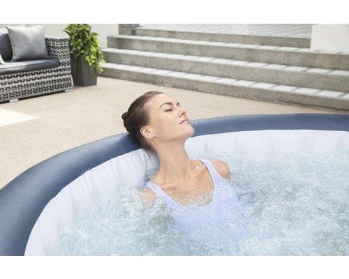 Frau entspannt im aufblasbaren Whirlpool im Garten