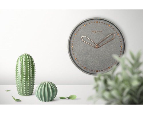 Dekorative Szene mit einer grauen Nextime Wanduhr und grünen Kakteenfiguren