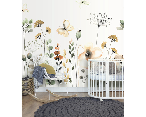 Dekoriertes Kinderzimmer mit Blumentapete, Schaukelstuhl und Kinderbett