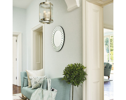 Eingangsbereich mit einer Bank, einem runden Spiegel, einer Hängelampe und einer Zimmerpflanze