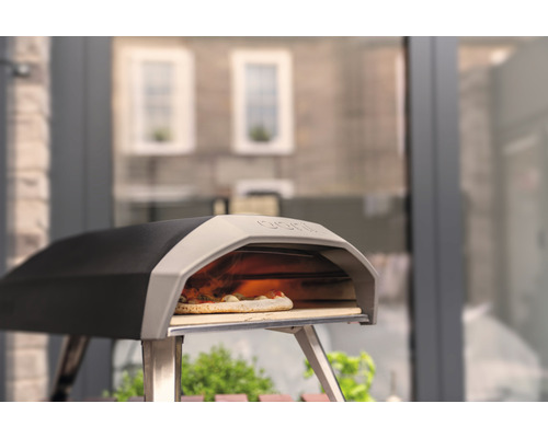Pizzaofen mit Pizza auf einem Pizzastein