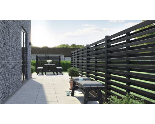 Terrasse mit Holzzaun, Sitzbank und Tischgruppe für den Außenbereich.