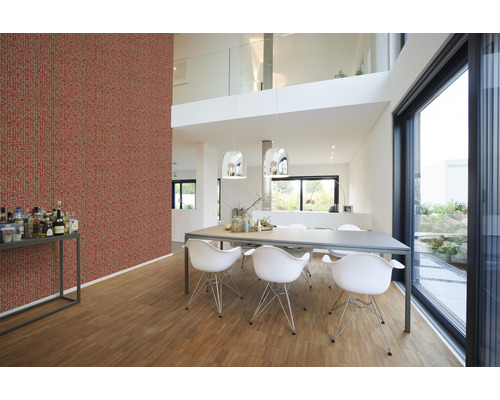 Helles Esszimmer mit roter Mustertapete, Esstisch und Stühlen.