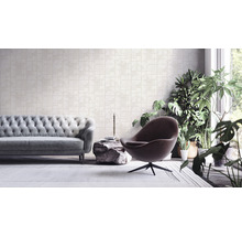 Wohnzimmer mit Sofa, Sessel, Zimmerpflanzen und gemusterter Tapete