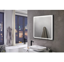 Modernes Badezimmer mit beleuchtetem Spiegel, Waschbecken und Badewanne
