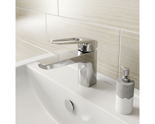 Glänzender Waschtischmischer auf einem Waschbecken mit Seifenspender.