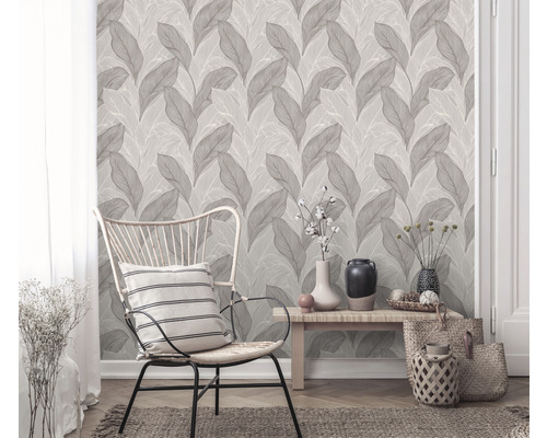 Wohnraum mit Blattmuster-Tapete, Stuhl und Dekoration für ein stilvolles Ambiente
