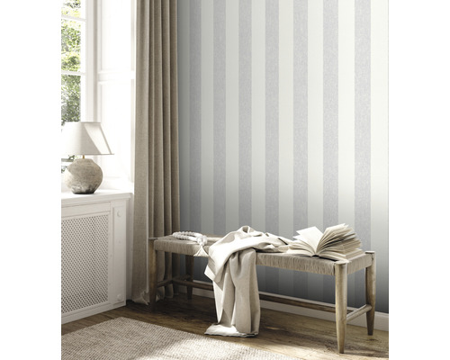 Wohnraum mit gestreifter Tapete, Sitzbank und Dekoration für ein gemütliches Ambiente.