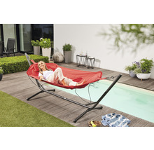 Frau entspannt in Hängematte mit Gestell im Garten.