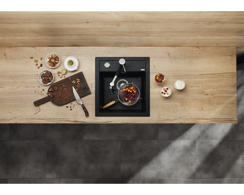 Küchenszene mit Spüle, Armatur, Schneidebrett, Obst und Zutaten auf einer Arbeitsplatte