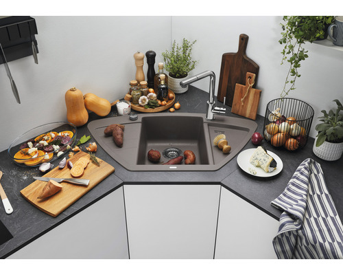 Eckspüle aus Verbundwerkstoff mit Armatur in einer Küche mit Lebensmitteln und Utensilien