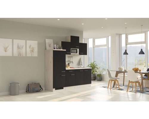 Moderne Küche mit Ober- und Unterschränken, Spüle und Mikrowelle in einem hellen Wohnraum.