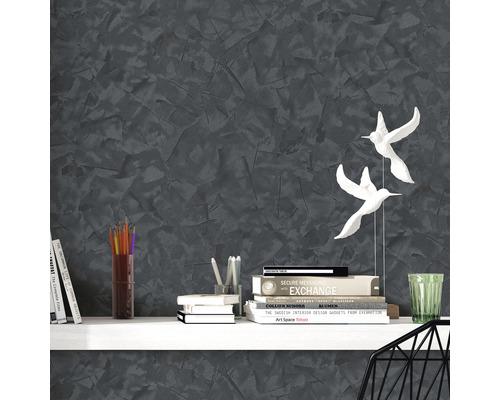 Dekoratives Interieur mit grauer Wandgestaltung, Bücherregal und Dekorationsgegenständen