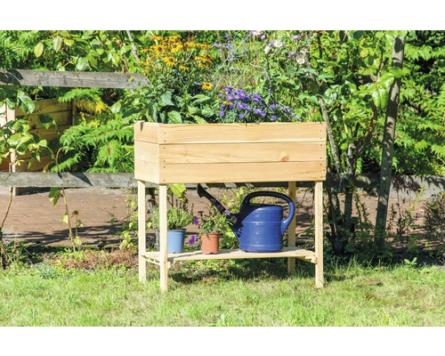 Hochbeet aus Holz mit Ablage und Blumen bepflanzt im Garten.