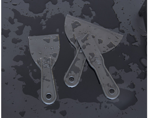 Drei Spachtel aus Kunststoff auf dunklem Untergrund