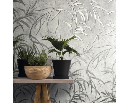 Wandgestaltung mit grauer Blättertapete und Pflanzen auf einem Tisch