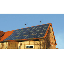 Hausdach mit Solaranlage und zwei Windrädern zur Energiegewinnung