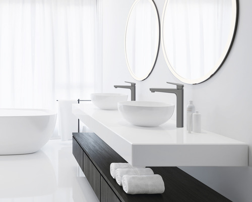 Helles Badezimmer mit Doppelwaschtisch, Aufsatzwaschbecken, Armaturen, runden Spiegeln und Badewanne