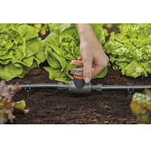 Gardena Micro-Drip-System mit Hand im Gartenbeet zur Bewässerung von Pflanzen