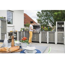 Outdoor-Küche mit Grill und Holzküchenschränken auf einer Terrasse mit gedecktem Tisch