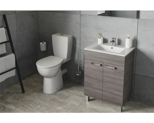 Badezimmer mit Toilette, Waschbeckenunterschrank, Handtuchhalter und Bad-Accessoires.