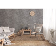 Wohnzimmer mit grauer Tapete mit floralem Muster, Sofa, Sessel und Dekoration