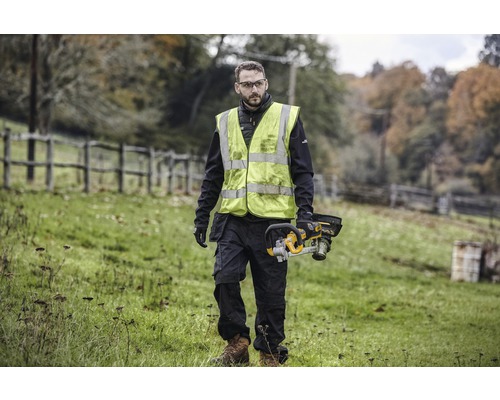 Mann mit Sicherheitsweste und Akku-Kettensäge im Freien