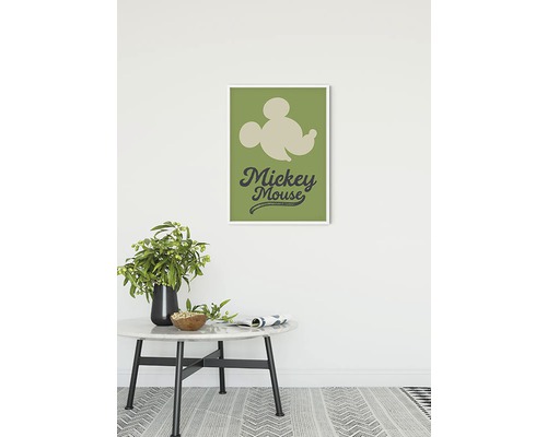 Dekoratives Mickey Mouse Wandbild im Rahmen über einem Tisch