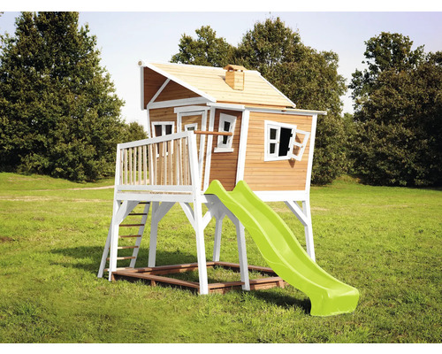Spielhaus aus Holz mit Rutsche im Garten.