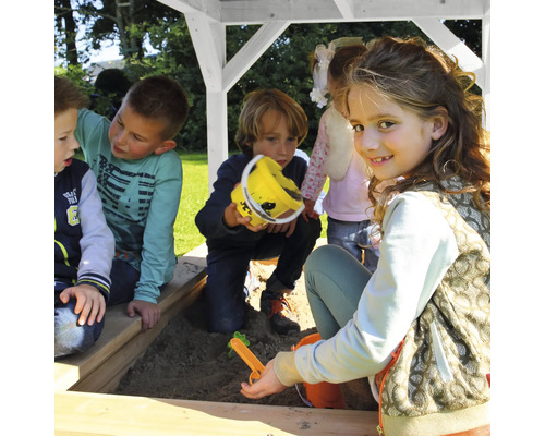 Kinder spielen im Sandkasten mit Spielzeug