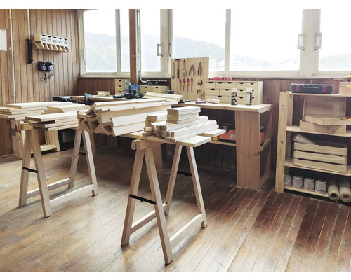 Werkraum mit Holzböcken und Holzstapeln