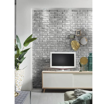 Wohnzimmer mit grauer Ziegelwand, Fernseher und weißem Sideboard
