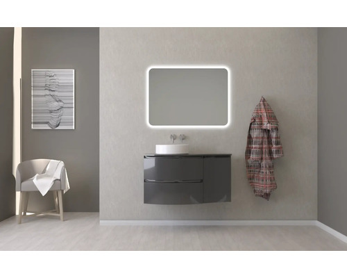 Badezimmer mit Waschtischunterschrank, Waschbecken, beleuchtetem Spiegel und Dekoration für eine helle und organisierte Atmosphäre.