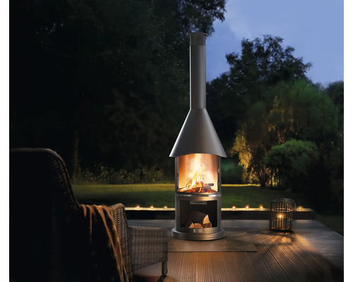 Metall-Außenkamin mit Holz auf Terrasse im Garten