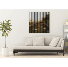 Wohnzimmer mit Sofa und gerahmtem Bild mit vertikalen Streifen, das zwei anstossende Weingläser zeigt.