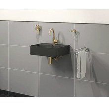 Modernes Badezimmer mit schwarzem Waschbecken, goldener Armatur und Handtuchhalter