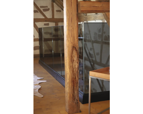 Innenaufnahme eines Hauses mit Holzstütze und Glasgeländer.