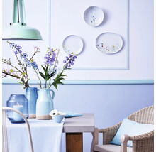 Dekoratives Esszimmer mit Tisch, Stuhl, Vasen, Blumen und Wanddekoration