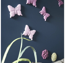 Wanddekoration mit Schmetterlings- und Blumenmotiven an einer blauen Wand