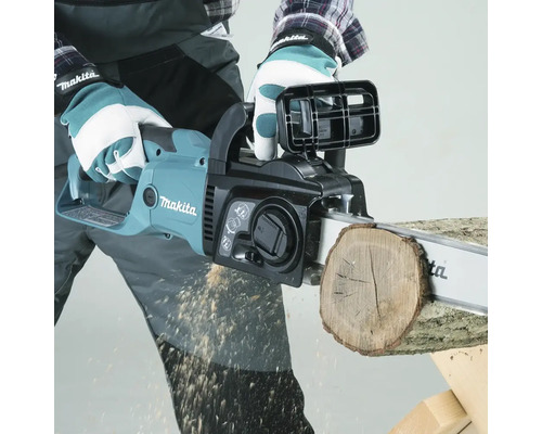Bedienende Person sägt mit einer Makita Kettensäge ein Holzstück.